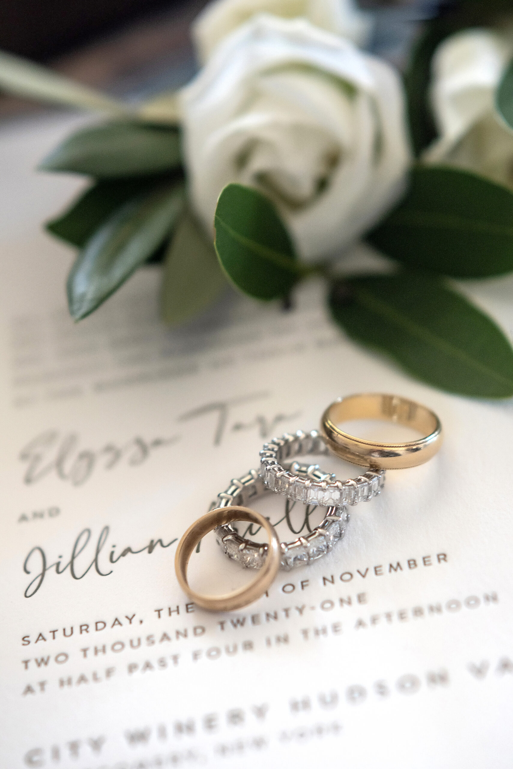 Rings on top of a wedding invitation