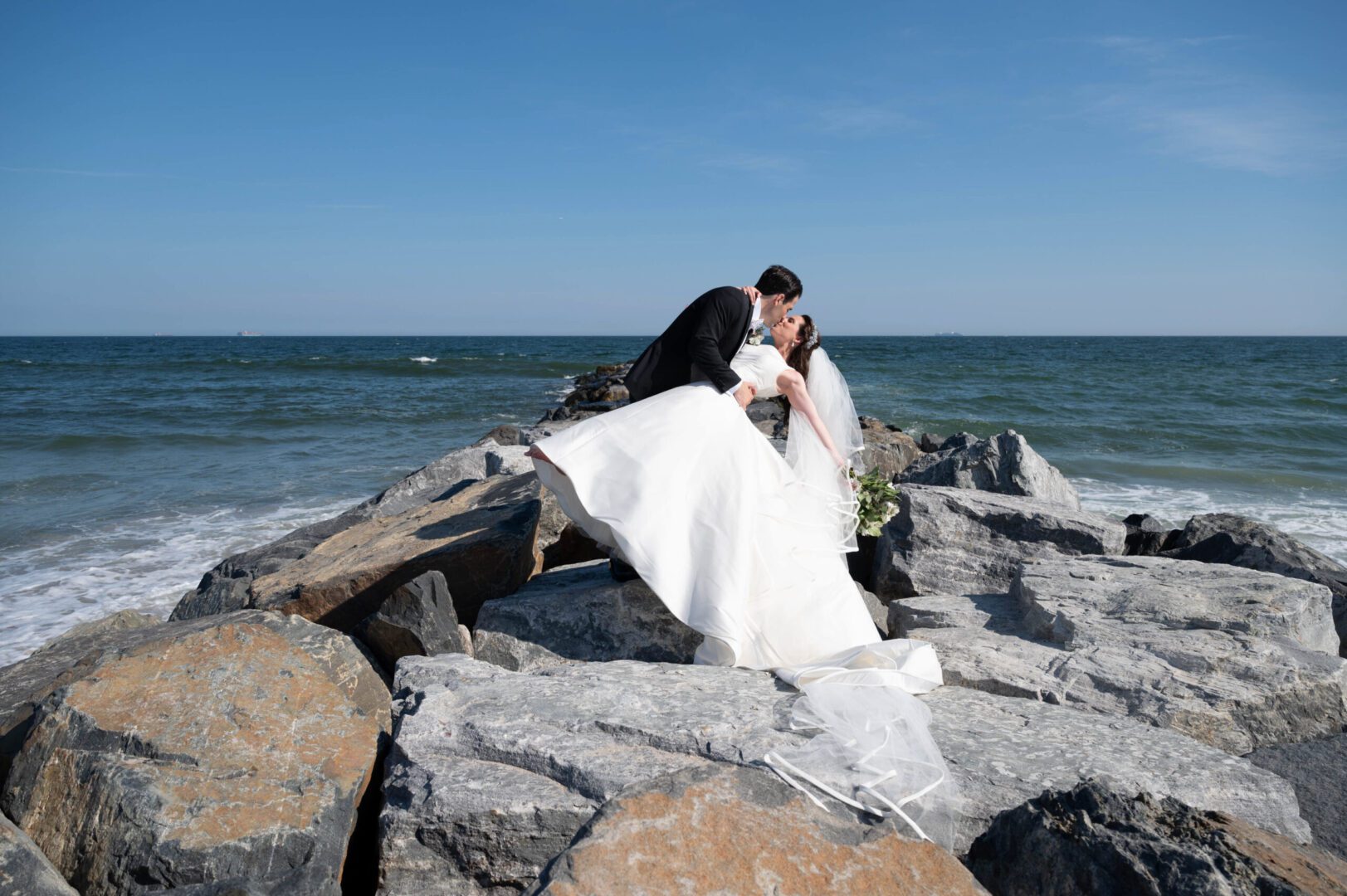 Happy married couple in a sea rock